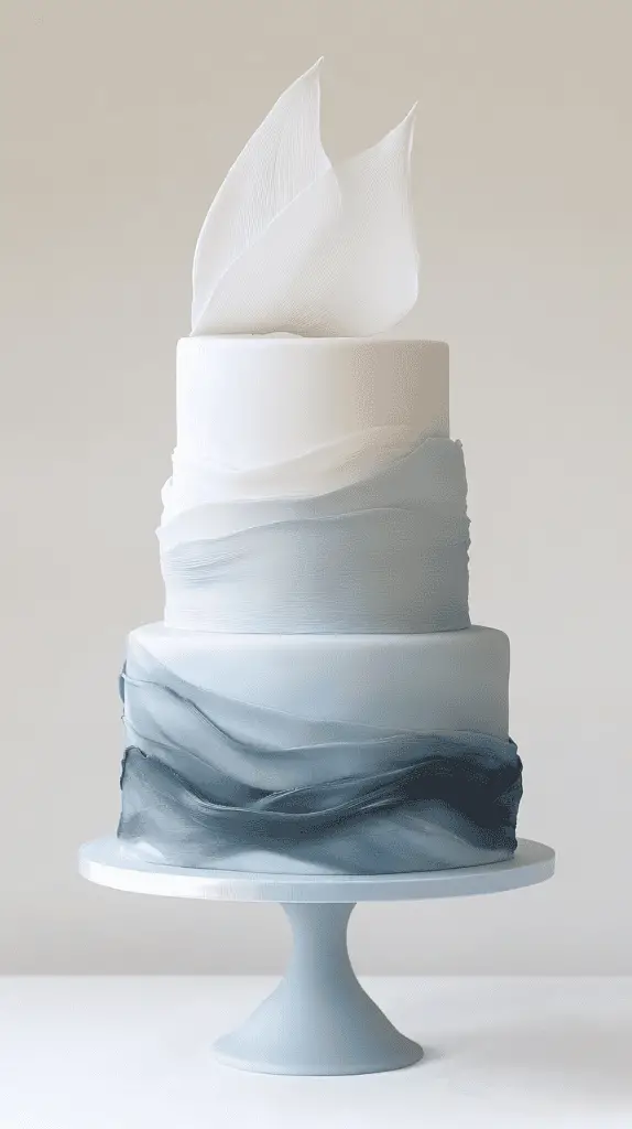 Artistic minimalist coastal opalite wedding cake with a smooth fondant base in pale blue and grey-blue hues
